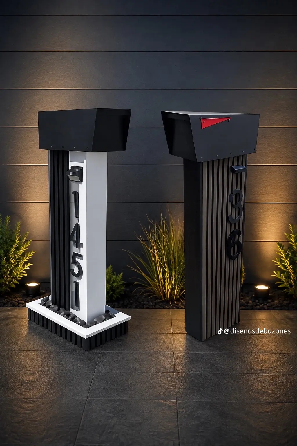 Two black mailboxes on narrow slatted pedestals, one with a white panel of vertical address numbers and a small light